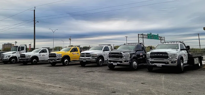 Line of Texas Roadside Services flatbed and wrecker trucks in San Antonio