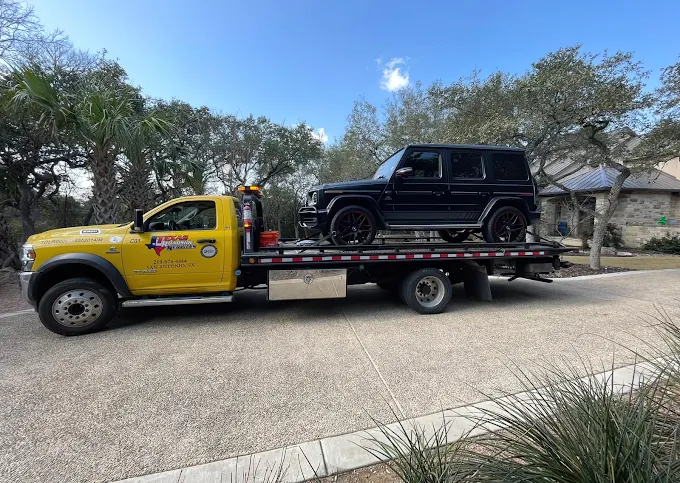 Mercedes G-Wagen hauled on a flatbed in a San Antonio driveway